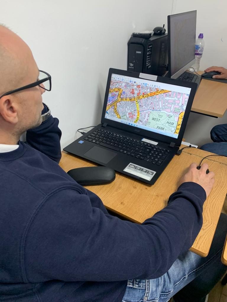 A driver practising route planning on a topographical map at London Paragon College